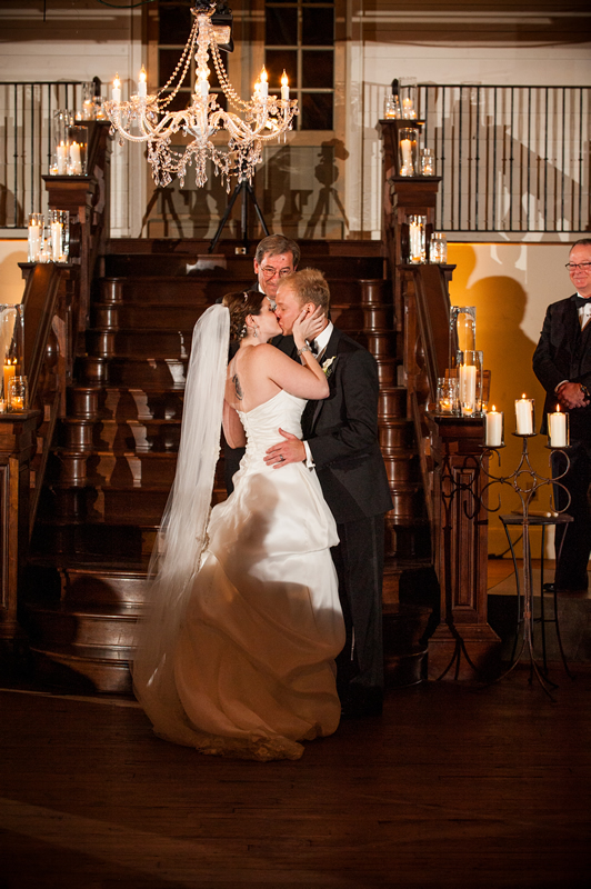 A couple takes vows by the grand staircase at Summerour Studio.